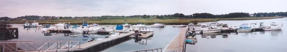 Boats at the docks of Town River Marina on a calm bay